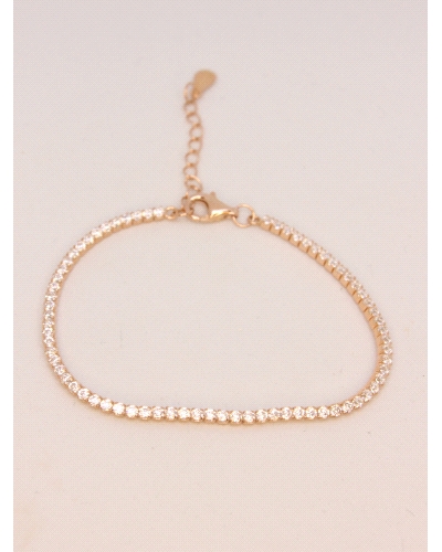 Pulsera tipo tennis elaborada en plata 925 y baño de oro rosa, con una delicada hilera de circonias blancas finamente engastadas