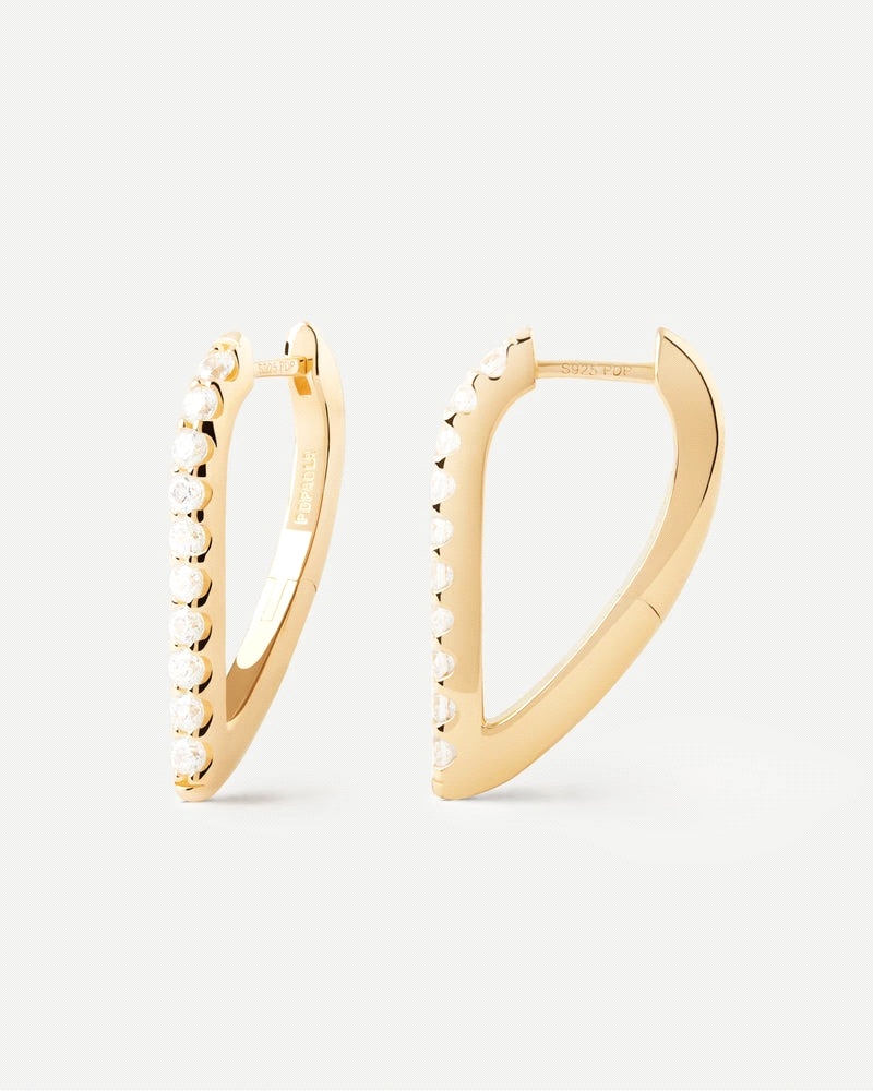 Aros geométricos con forma ovalada y circonitas blancas.<BR>