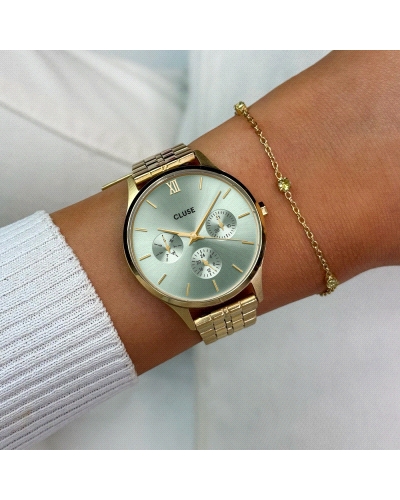 El reloj círculo Minuit Multifunction para mujer tiene una caja color oro de 34 mm, una esfera verde salvia con 3 subesferas y u